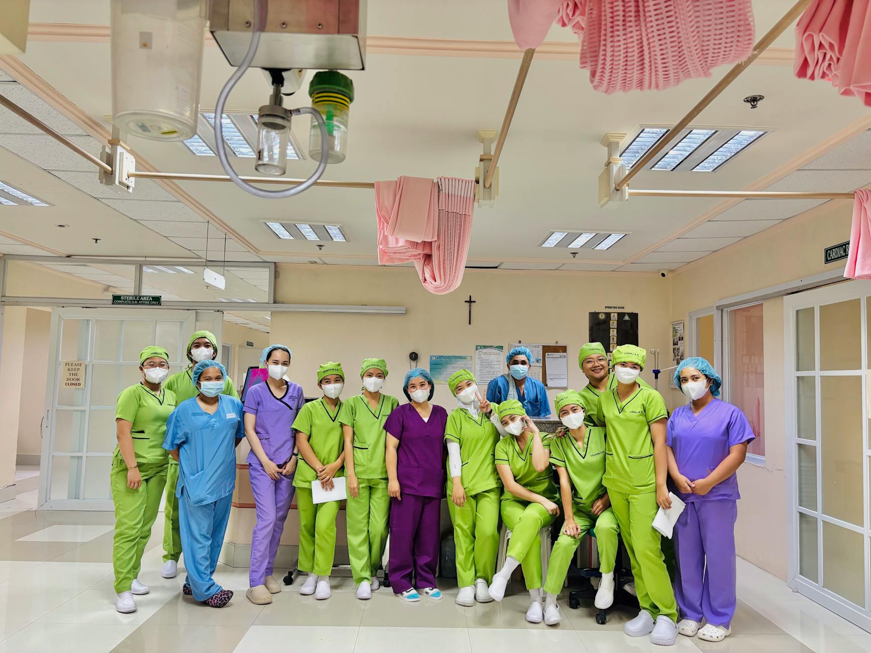 Group of diverse nurses in vivid scrubs inside a hospital ward, Baguio City.